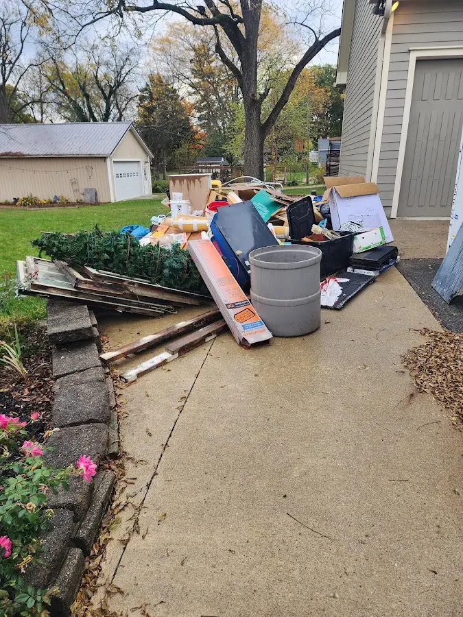 Dumpster being loaded with debris for Commercial Dumpster Rental in Rockwood